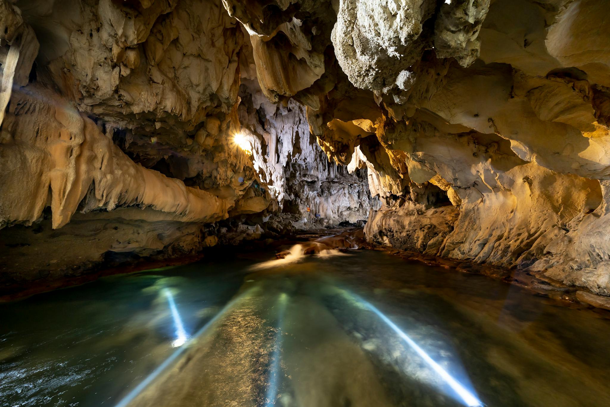 Explore a magnificent cave featuring unique rock formations and a serene underground river.