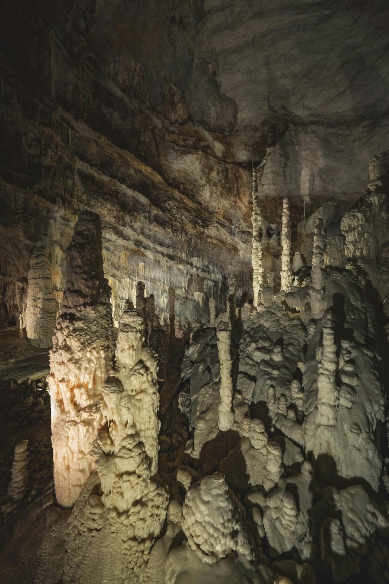 Explore the stunning stalactites and stalagmites in Frasassi Caves, Italy.
